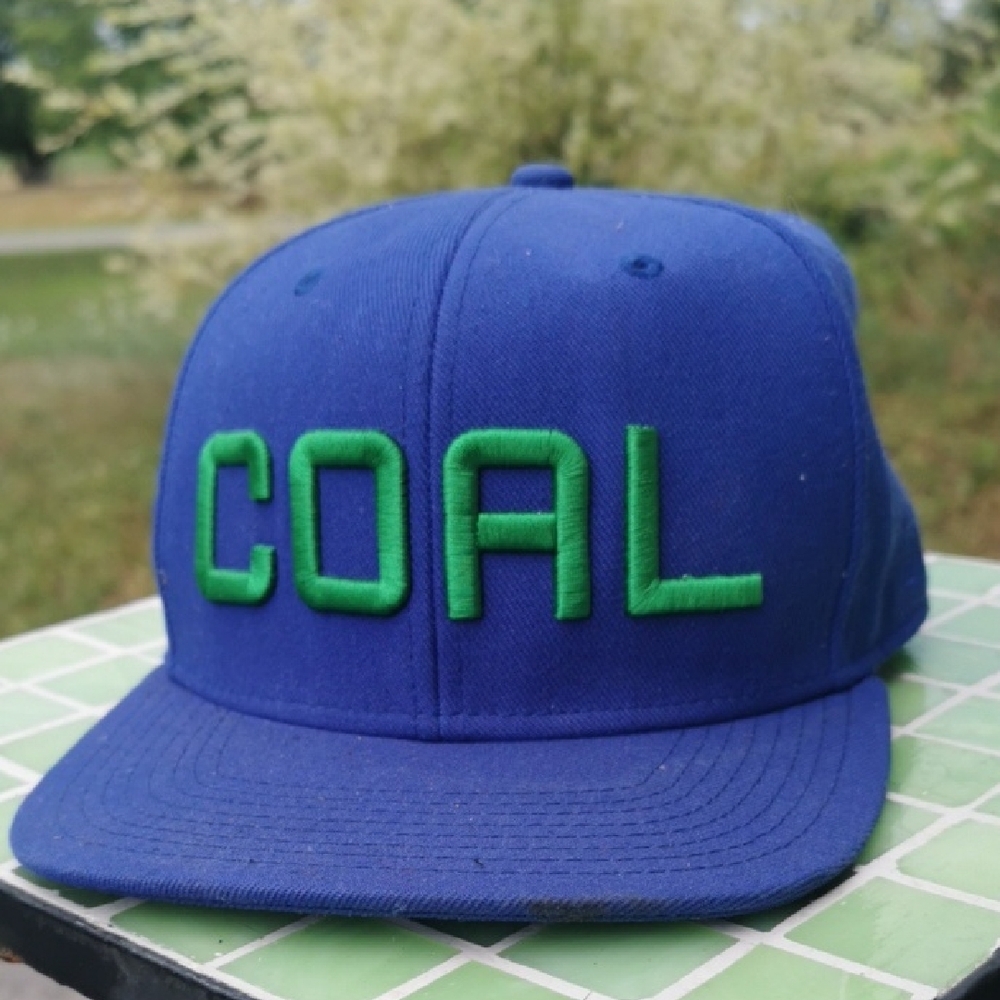 COAL headwear trucker hat with green writing. Adjustbable. Unisex